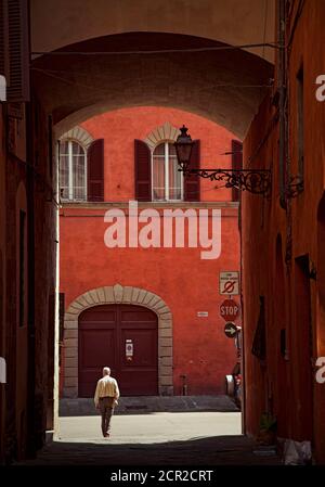 House, alley, man, Pistoia, Tuscany, Italy Stock Photo