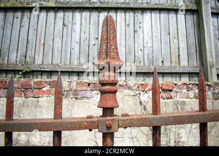 A Rusty Spike on an Old Black Metal Fence Stock Photo