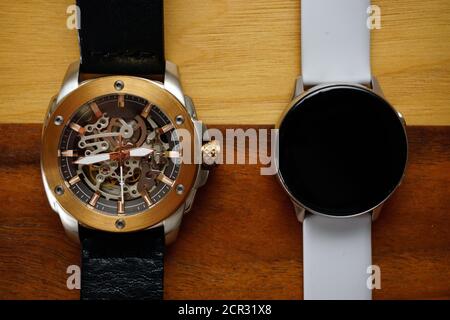 Analog and smart watches on wooden background with copyspace Stock Photo