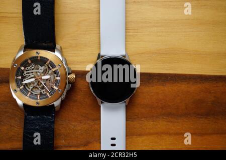 Analog and smart watches on wooden background with copyspace Stock Photo