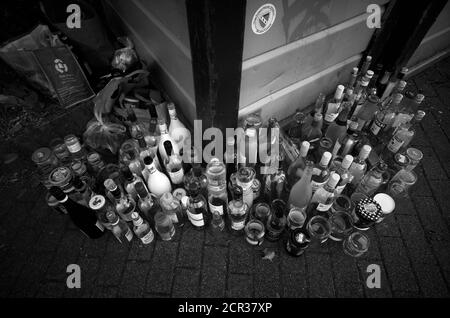 Empty bottles in front of overfilled waste glass containers, Stuttgart, Baden-Württemberg, Germany Stock Photo