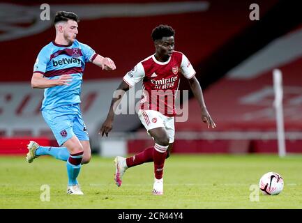 Arsenal's Bukayo Saka (left) and Declan Rice celebrate with the trophy ...