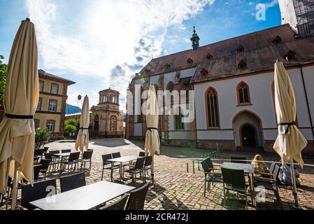 In the morning on the square in front of the collegiate church, in the foreground tables and chairs from a restaurant. Stock Photo