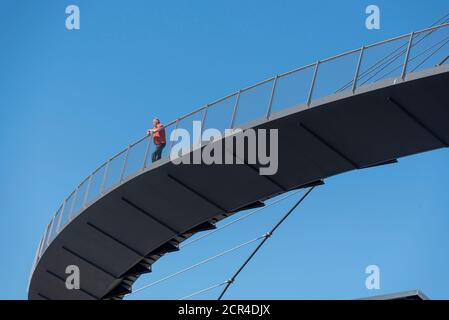 Germany, Mecklenburg-Western Pomerania, Ruegen island, a man stands on the pedestrian bridge in the city harbor of Sassnitz, 274 m long suspension Stock Photo