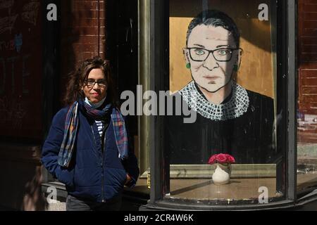 New York City, USA. 19th Sep, 2020. Artist Julie Gaines stands next to her portrait of Ruth Bader Ginsburg, Associate Justice of the Supreme Court of the United State who died on September 18, in New York, NY, September 19, 2020. Julie Gaines is also the owner of Fishs Eddy where the painting is on display in the front window. (Anthony Behar/Sipa USA) Credit: Sipa USA/Alamy Live News Stock Photo