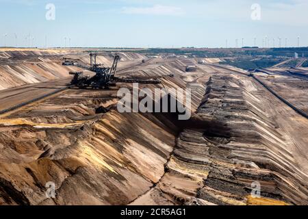 Juechen, North Rhine-Westphalia, Germany - shifting excavator in the RWE lignite opencast mine Garzweiler, Rheinisches lignite area, wind turbines in Stock Photo