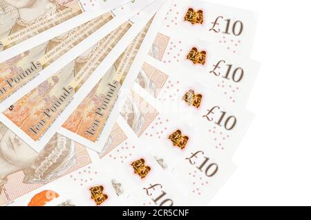 10 British pounds bills lies isolated on white background with copy space stacked in fan shape close up. Financial transactions concept Stock Photo