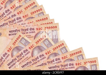 10 Indian rupees bills lies isolated on white background with copy space stacked in fan close up. Payday time concept or financial operations Stock Photo