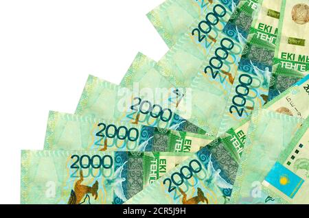 2000 Kazakhstani tenge bills lies in different order isolated on white. Local banking or money making concept. Business background banner Stock Photo