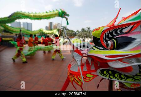 Men perform a dragon dance ahead of Chinese Lunar New Year in Phnom Penh, Cambodia February 12, 2018. REUTERS/Samrang Pring
