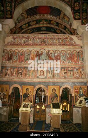 Borzești Orthodox Church in Onești, Bacău County, Romania. The iconostasis covered in frescoes with New Testament scenes and characters. Stock Photo