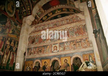 Borzești Orthodox Church in Onești, Bacău County, Romania. The iconostasis covered in frescoes with New Testament scenes and characters. Stock Photo