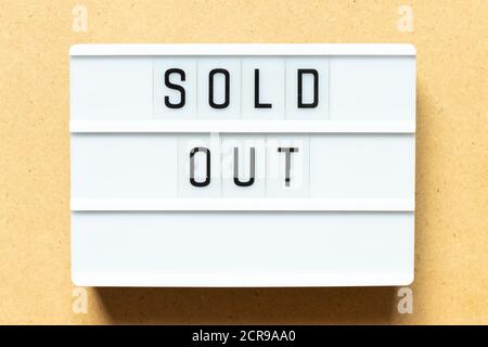 Lightbox with word sold out on wood background Stock Photo