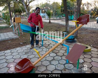 DISTRICT KATNI, INDIA - JANUARY 23, 2020: An indian science teacher presenting See Saw model concept at educational park. Stock Photo