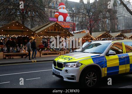 Police car patrols in front of the Christmas market in Manchester, Britain, December 20, 2016. REUTERS/Phil Noble