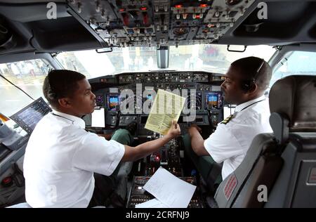 Pilots sit in the cockpit as they prepare the Ethiopian Airlines ET314 flight to Eritrea's capital Asmara at the Bole International Airport in Addis Ababa, Ethiopia July 18, 2018. REUTERS/Tiksa Negeri