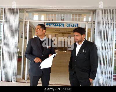 DISTRICT KATNI, INDIA - JANUARY 27, 2020: Two Indian lawyers standing together at Supreme court premises. Stock Photo
