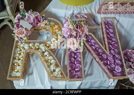 Transparent chocolate box . Yellow and pink letters R and N chocolate . Stock Photo