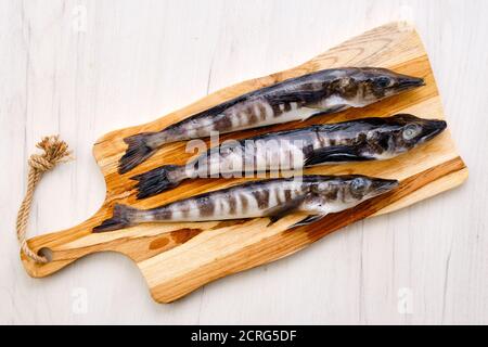 Top view of raw fresh icefish on wooden cutting board Stock Photo