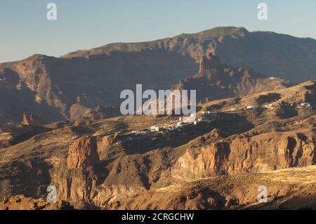 Roque Palmes in the foreground, village of El Toscon and Roque Bentaiga in the background. The Nublo Rural Park. Gran Canaria. Canary Islands. Spain. Stock Photo