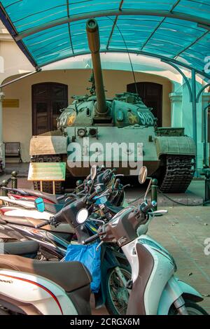 HANOI, VIETNAM, APR 20 2019, motorcycles parked in front of an old Russian tank, areal of museum Stock Photo