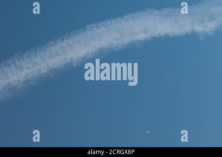 Aircraft vapour trail and moon. Gran Canaria. Canary Islands. Spain. Stock Photo