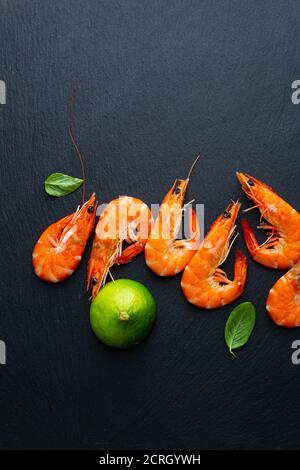 Overhead view of Cooked tiger prawns with lime Stock Photo