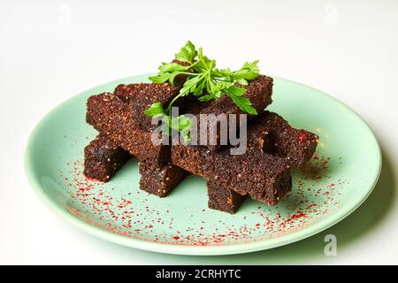 Rye bread croutons with garlic, spices and parsley as a beer snack Stock Photo