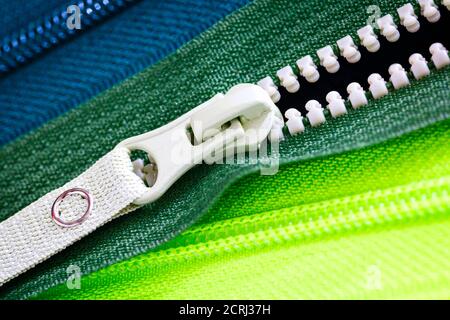 Zip background texture of zippers sliders. a lot of zippers in different colors. sewing clothes, atelier, fabric and accessories shop. hobby diy conce Stock Photo