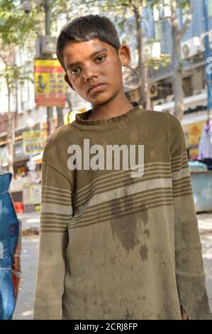 A indian child beggar asking for money for buying food. Stock Photo