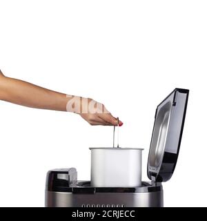 Bread maker isolated on white background. Home electronic programmable bread maker with open lid.Side view, inside. Get out  baking pan. Stock Photo