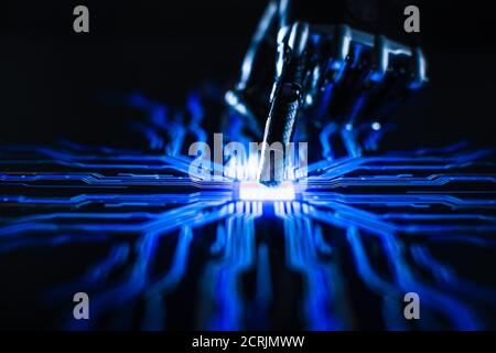 Digitalization Concept: Futuristic Robot Arm Interacting with Screen, Finger Touches Display and Activates Artificial Intelligence. Visualization of Stock Photo