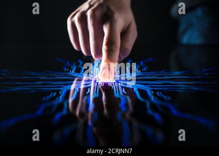 Digitalization Concept: Human Finger Pushes Touch Screen Button and Activates Futuristic Artificial Intelligence. Visualization of Machine Learning Stock Photo
