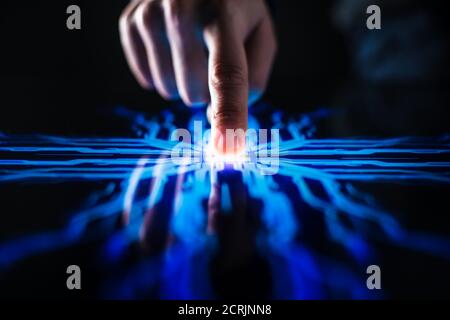 Digitalization Concept: Human Finger Pushes Touch Screen Button and Activates Futuristic Artificial Intelligence. Visualization of Machine Learning Stock Photo