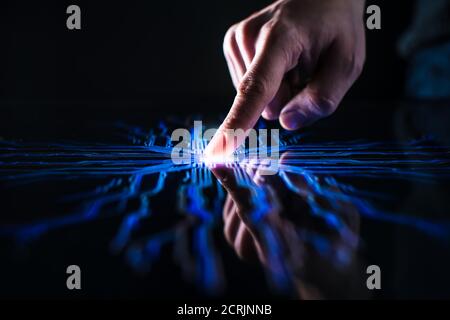 Digitalization Concept: Human Finger Pushes Touch Screen Button and Activates Futuristic Artificial Intelligence. Visualization of Machine Learning Stock Photo