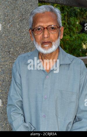 A indian old age uncle poses for portfolio shoot at outside of studio. Stock Photo
