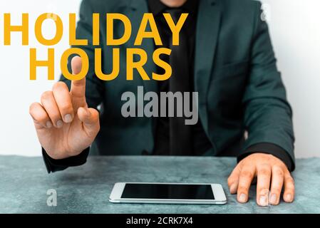 Handwriting text writing Holiday Hours. Conceptual photo employee receives twice their normal pay for all hours Model displaying black screen modern s Stock Photo