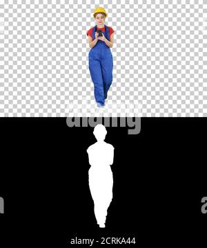 Female worker walking and using phone, Alpha Channel Stock Photo