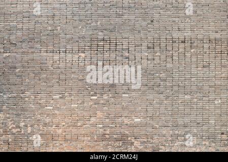 Weathered stained old brick wall background on surface Stock Photo