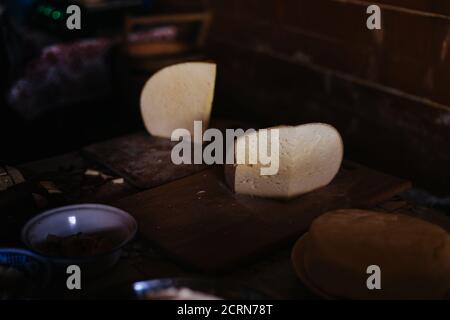 Tasty homemade cheese in the countryside on the wooden table Stock Photo