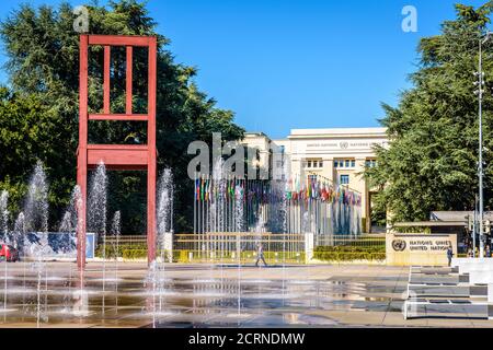 The 'Broken Chair' sculpture stands in the Nations square, opposite the Palace of Nations, home of the United Nations Office at Geneva, Switzerland. Stock Photo