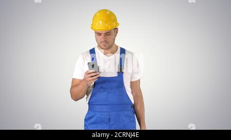 Factory worker employee chatting browsing texting on smartphone Stock Photo