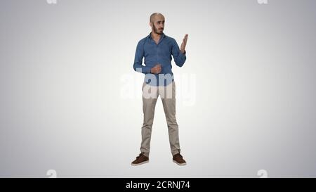 Arabic young man in shirt talking presenting something and point Stock Photo