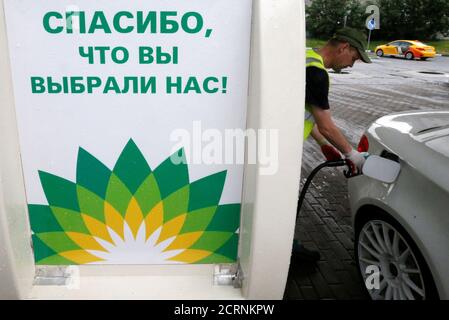 An employee fills the tank of a car at a BP petrol station in Moscow, Russia, July 4, 2016. The sign reads 'Thank you for choosing us!' REUTERS/Sergei Karpukhin