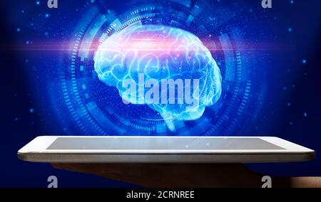 AI, Artificial Intelligence. Male Hand Holding Digital Tablet With Electronic Brain Hologram Stock Photo