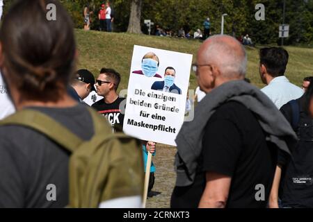 20 September 2020, North Rhine-Westphalia, Duesseldorf: A man holds a sign on the meadows of the Rhine, in front of a demonstration against the measures to combat the spread of the coronavirus. Photo: Roberto Pfeil/dpa