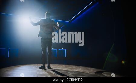 Famous Entertainer Gets on the Stage, Greets Audience, Starts Performance. Software Company Founder, Tech Marketing Guru Making a Pitch, Presentation Stock Photo