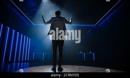 Famous Entertainer Gets on the Stage, Greets Audience, Starts Performance. Software Company Founder, Tech Marketing Guru Making a Pitch, Presentation Stock Photo