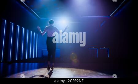 Famous Female Entertainer Gets on the Stage, Greets Audience, Starts Performance. Software Company Founder, Tech Marketing Guru Making a Pitch Stock Photo