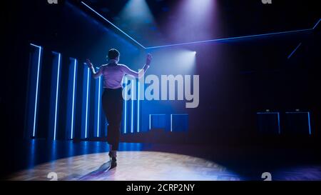 Famous Female Entertainer Gets on the Stage, Greets Audience, Starts Performance. Software Company Founder, Tech Marketing Guru Making a Pitch Stock Photo